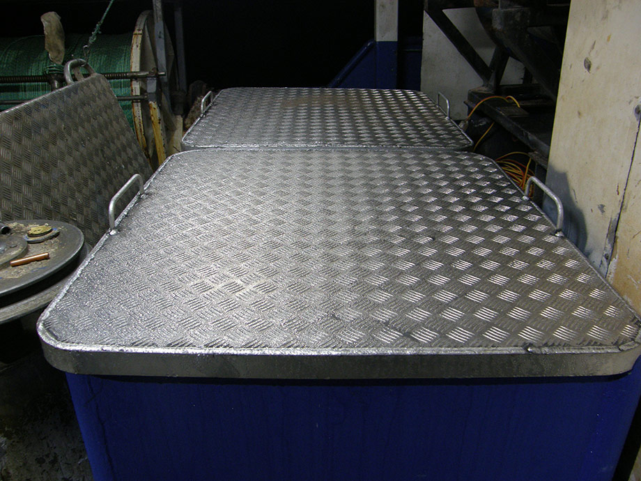 Commercial fishing vessel, brine tank lids showing condensation as refrigeration system operating.