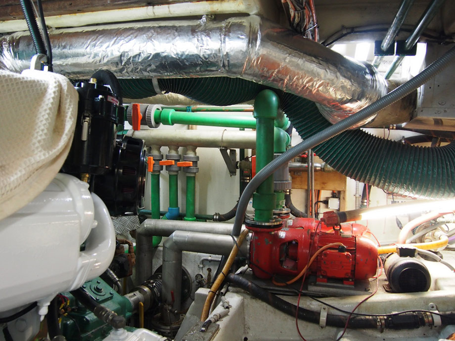 New main engine install for commercial fishing vessel in Ulladulla NSW. Photo in back ground showing live bait tank plumbing pipe work, valving and pumps, installed in 2002.