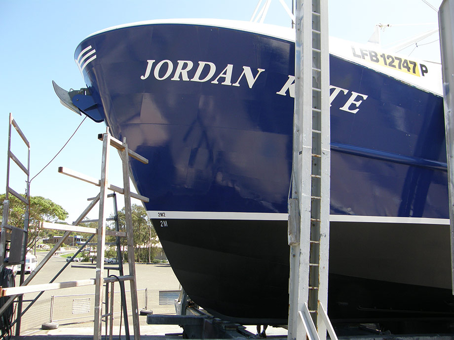 Commercial fishing vessel, bow section with touch up of blue, boot line and antifoul.