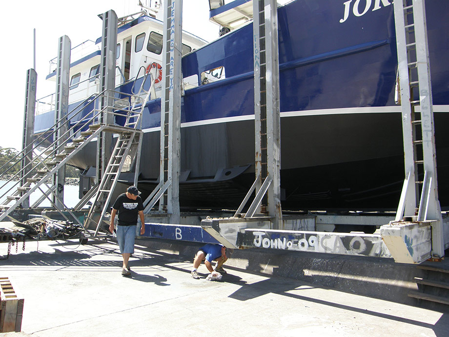 Commercial fishing vessel after water blast of bottom and the painting of antifoul. Painted the boot line in white and painted the blue of the hull from the boot line to the underside of the sponson.