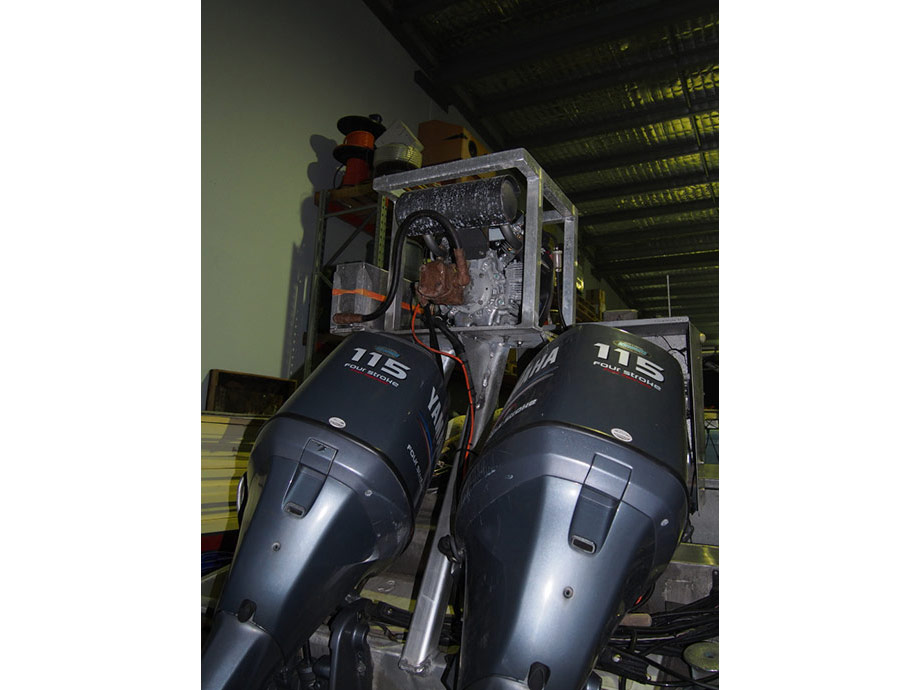 Commercial fishing vessel, stern view of V twing Honda and hydraulic setup. 