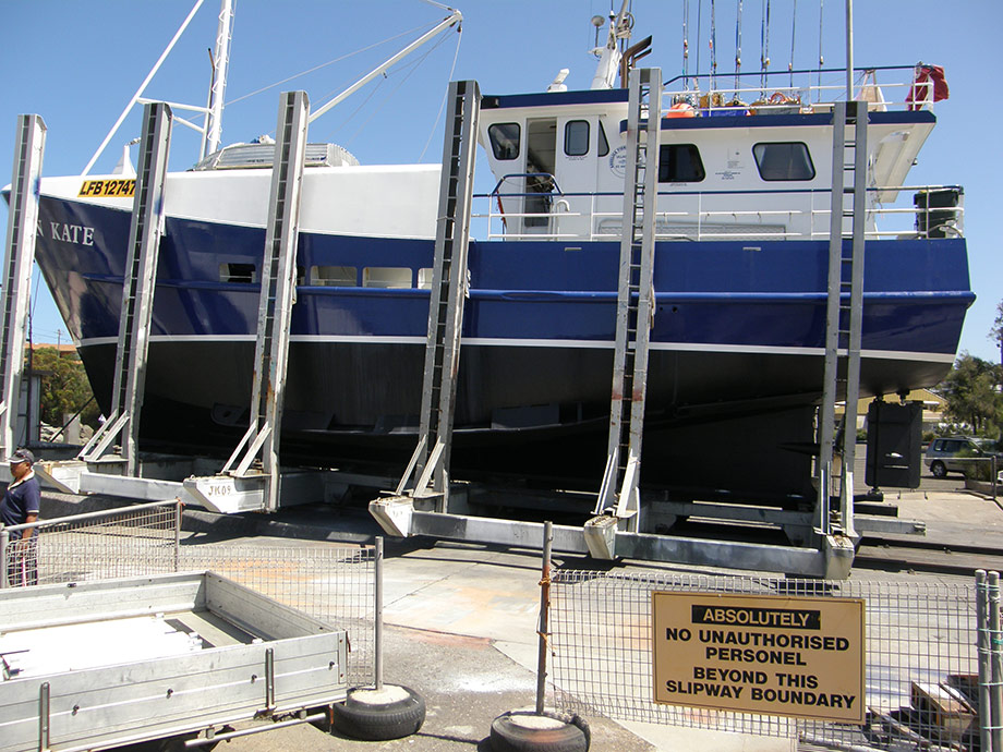 Commercial fishing vessel, painting of bottom , boot line and blue up to the sponson.